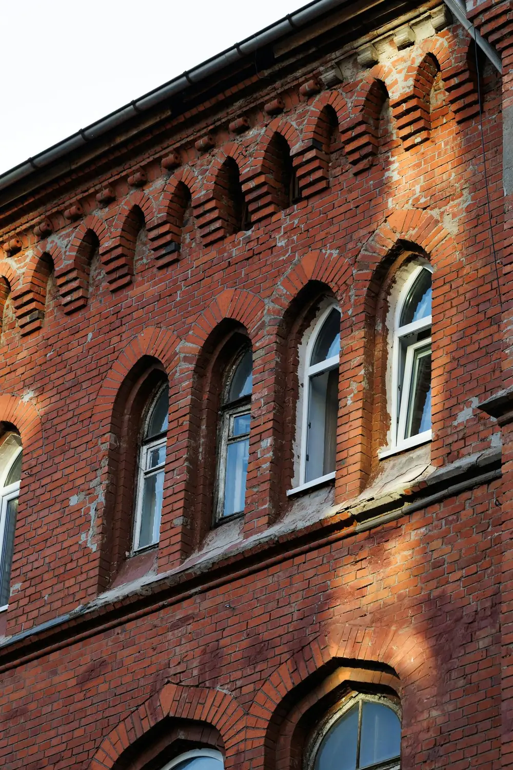 A Victorian brick building with arched windows